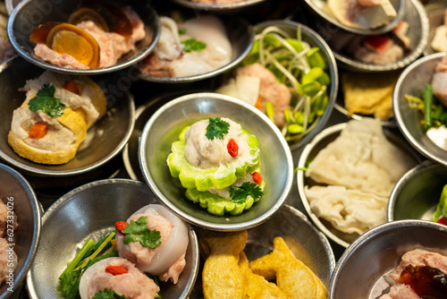 Various type of Dim sum, famous chinese appertizer food which are prepared in stainless plate. Raw food menu object photo, close-up and selective at top.