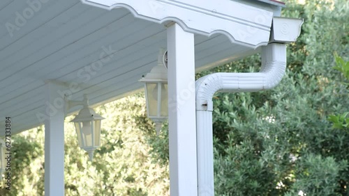 Metallic Guttering System, Guttering, Drainage Pipe Exterior. Drainage on the roof near the shingles
