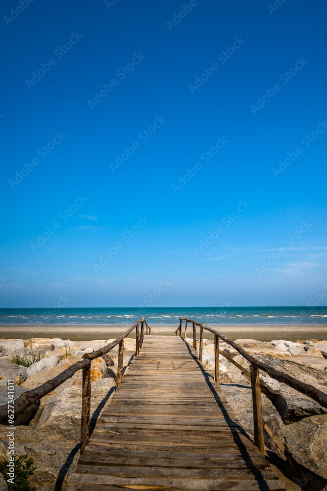 Wooden bridge walkway to the sea beach