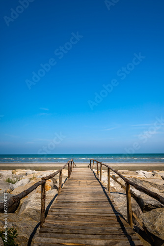 Wooden bridge walkway to the sea beach