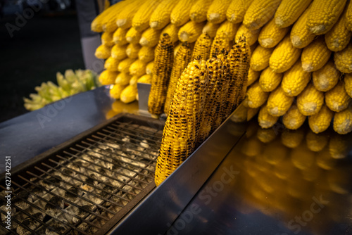 A street vendor roasts corn on a charcoal grill in Istanbul, Turkey. Misir, a popular Turkish street food, is freshly boiled or grilled sweet corn on the cob sprinkled with salt and spices.