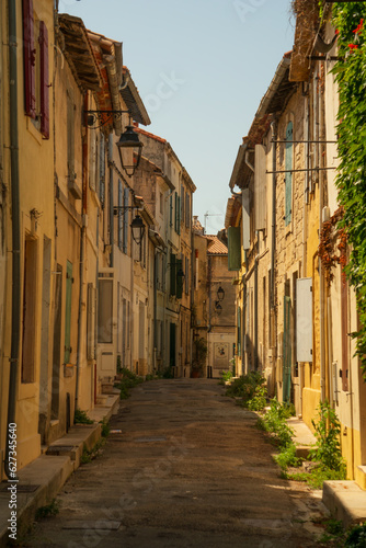 Fototapeta Naklejka Na Ścianę i Meble -  Street of old town of Arles, south France, mediterranean architecture, colourful buildings
