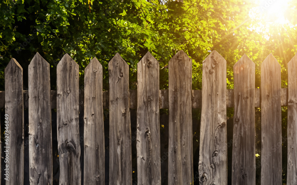 A wooden fence illuminated by sunlight with trees in background. AI generative A wooden fence illuminated by sunlight with trees in background. AI generative