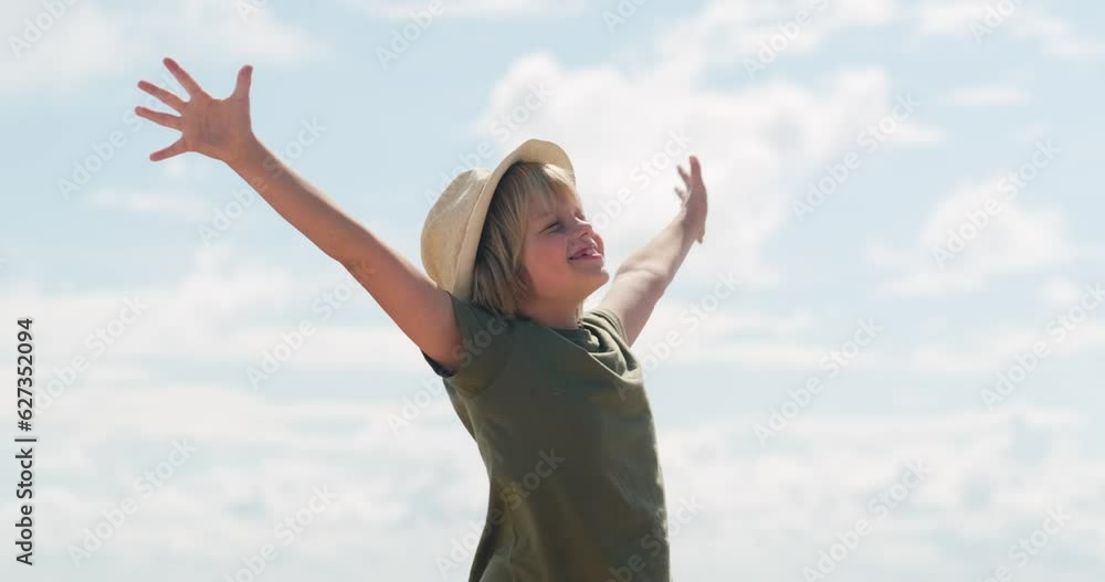 Happy relaxed boy in hat breathing fresh air raising arms over blue sky at summer, Dreaming, freedom and traveling concept. Happy relaxed boy in hat breathing fresh air raising arms over blue sky at summer, Dreaming, freedom and traveling concept.