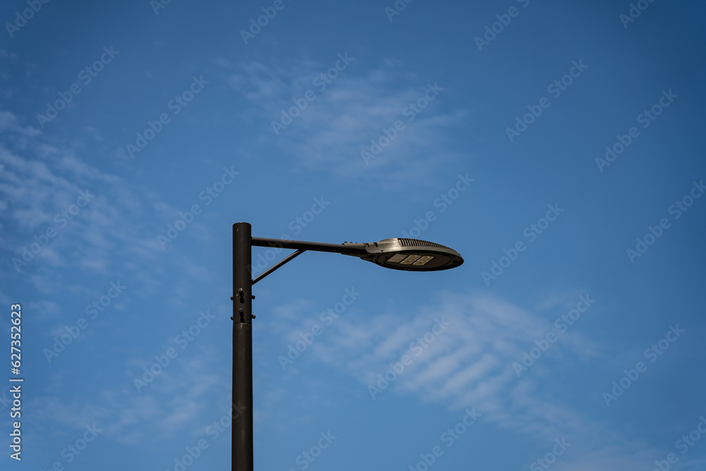 LED street lights turned off on a background of midday blue sky LED street lights turned off on a background of midday blue sky