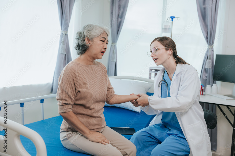 Obraz premium Young beautiful smiling doctor nurse caring to help happy senior grandmother helping old patients in rehabilitation at elderly health checkup