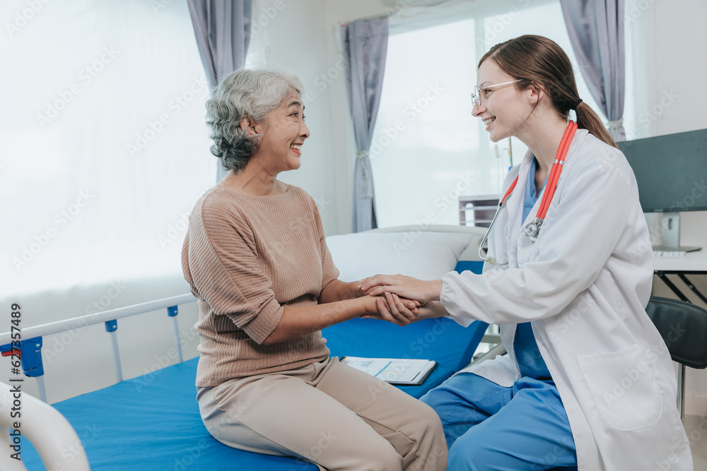 Fototapeta premium Young female doctor nurse caregiver caring happy senior grandmother helping old patients in rehabilitation at elderly health checkup
