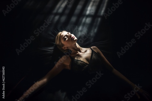An elegant ballerina in a noir dress, reclined on a dance studio floor, eyes closed in tranquility, dramatically caressed by a spotlight.