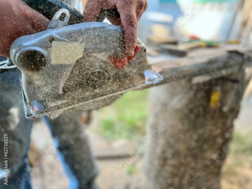 Wallpaper Mural Man carpenter cutting wood with circular saw creating new furniture Torontodigital.ca