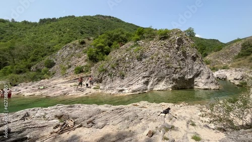 Beautiful view of river Bosso with people making a bath, Marche region, Italy photo