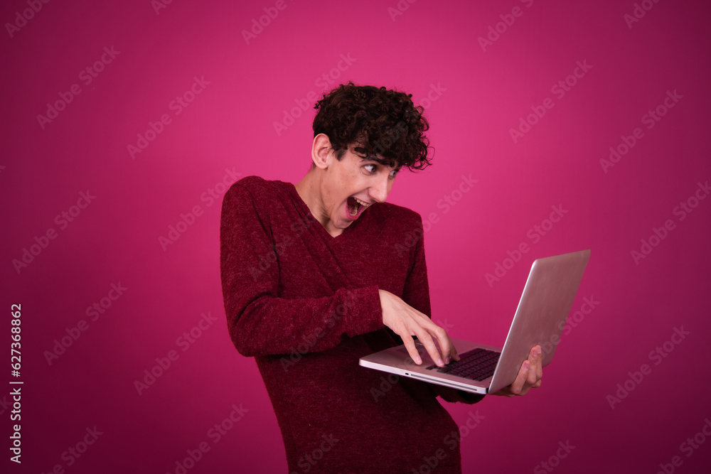 Funny student prepares for exams and goes shopping. The guy poses on a pink background. Funny student prepares for exams and goes shopping. The guy poses on a pink background.