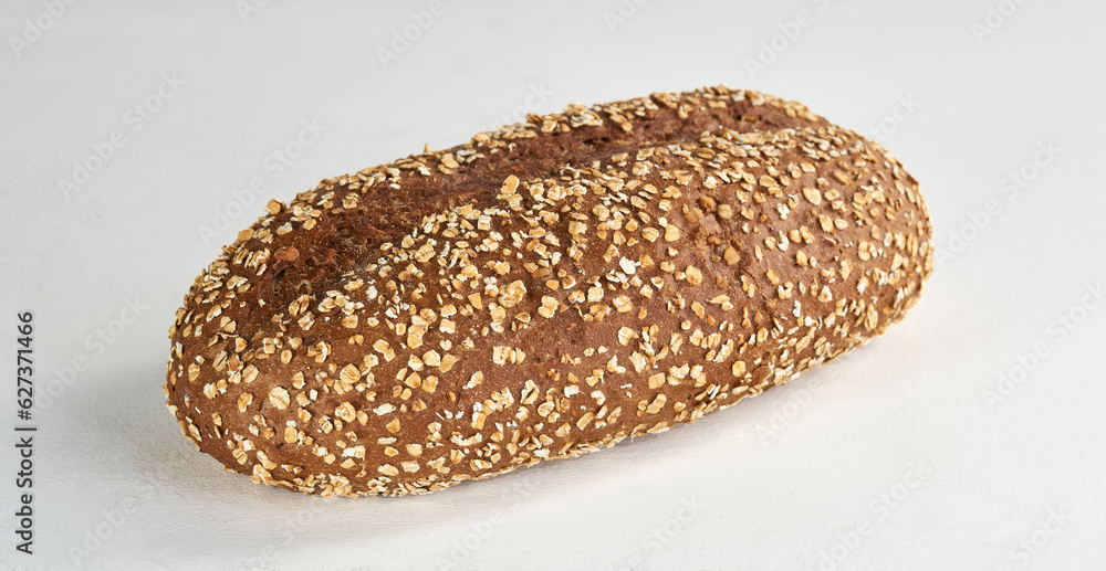 A closeup of a whole grain brown bread on white - isolated A closeup of a whole grain brown bread on white - isolated