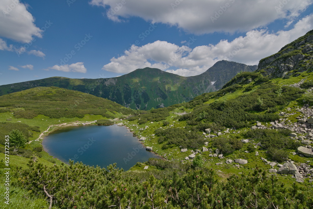 View to one of four Rohacske plesa mountain lakes in Vysoke Tatry mountains. Lakes  are 1719 metres above the sea surrounded by mountains peaks more than 2000 metres above the sea. Slovak nature.