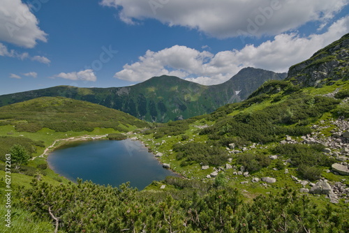 View to one of four Rohacske plesa mountain lakes in Vysoke Tatry mountains. Lakes  are 1719 metres above the sea surrounded by mountains peaks more than 2000 metres above the sea. Slovak nature.