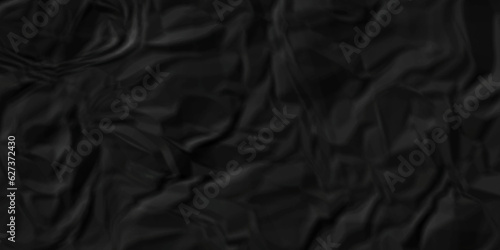 Black Crumpled black paper for background. used for cardboar wallpaper and wrinkled old backdrop top view. black satin background.