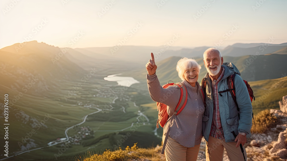 © Татьяна Прокопчук - Two happy active seniors having fun at the top of the mountain. Couple of mature people enjoying and having fun in vacations. Traveling  lifestyle
