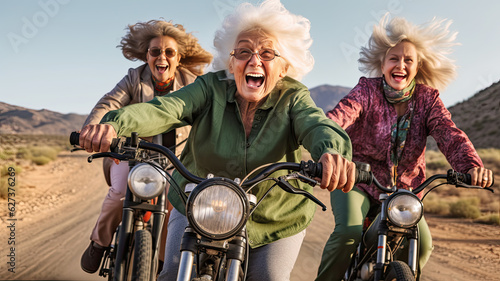 Three elderly attractive women with a happy expression on face ride bikes in the mountains