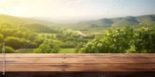 Empty wood table top with on blurred green vineyard landscape background in spring