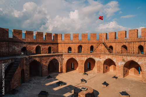 Fototapeta Naklejka Na Ścianę i Meble -  Upper part of the historical Red Tower (Kizil Kule), in Alanya Castle. The Red Tower is the symbol of the Alanya city, and the famous touristic place, Turkey (Turkiye).