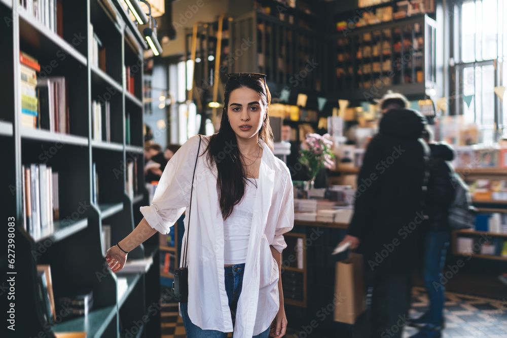 Confident ethnic woman in bookstore