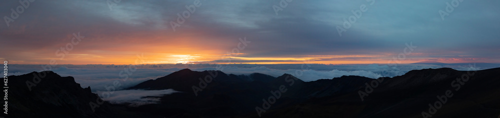 Scenic view of Haleakala from mountain top overlooking the Pacific Ocean above the clouds at sunrise; Haleakala National Park, Maui, Hawaii, United States of America
