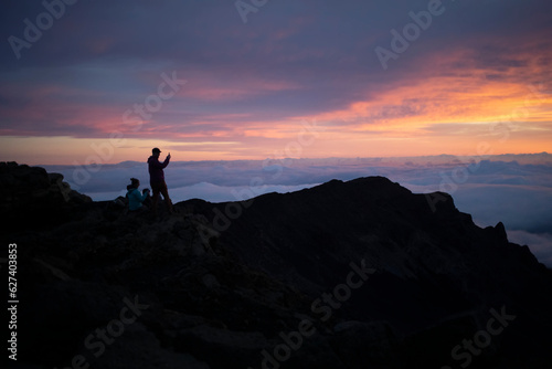 Family on a mountain top above the clouds at Haleakala watching the sunrise over the Pacific Coast  Haleakala National Park, Maui, Hawaii, United States of America © Designpics
