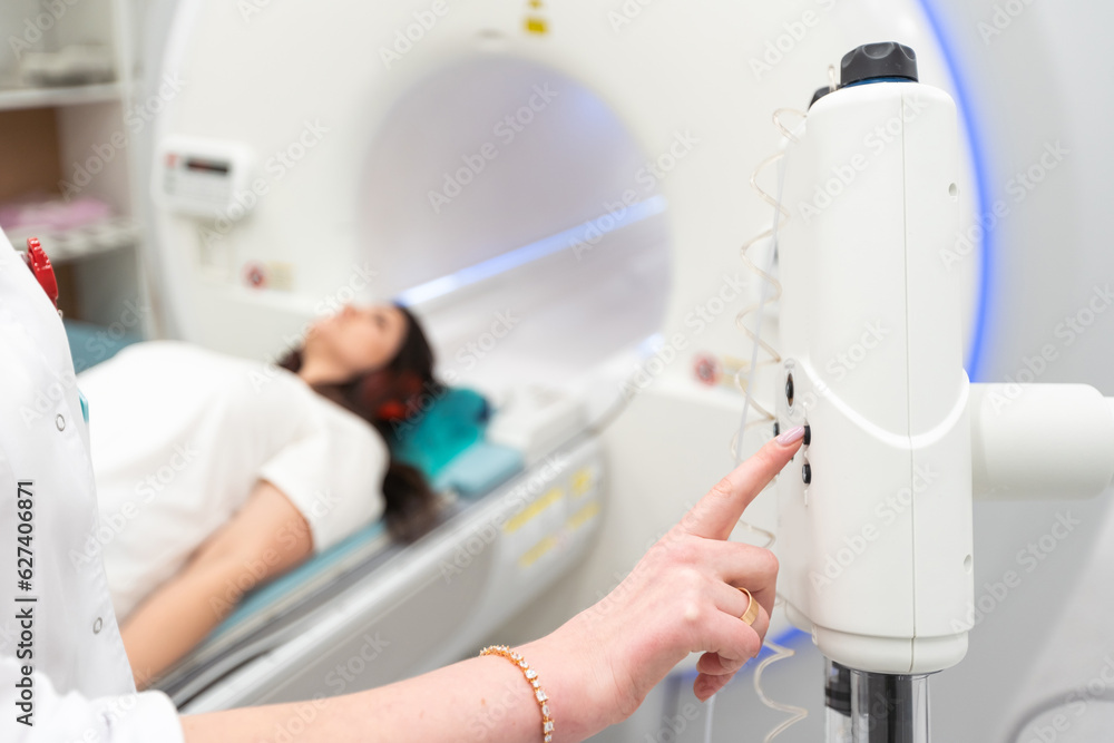 Medical CT or MRI Scan with a patient in the modern hospital laboratory. Interior of radiography department. Technologically advanced equipment in white room. Magnetic resonance diagnostics machine Medical CT or MRI Scan with a patient in the modern hospital laboratory. Interior of radiography department. Technologically advanced equipment in white room. Magnetic resonance diagnostics machine