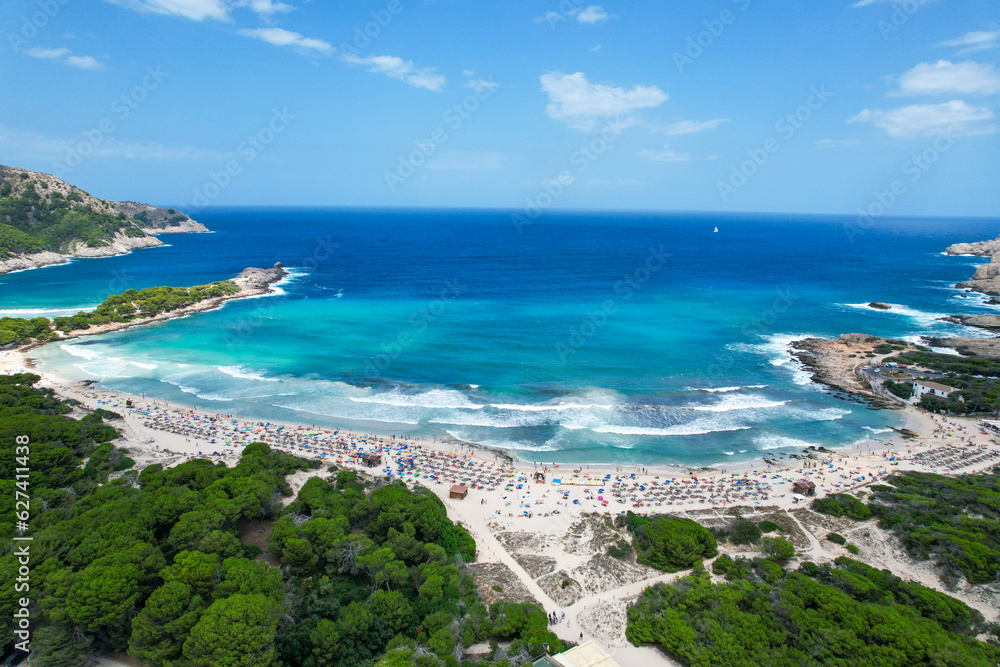 Aerial view of Cala Agulla beach in Mallorca, Spain, on a hot summer day