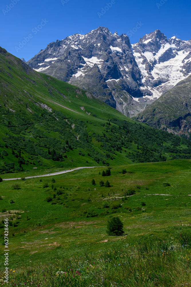 Mountains and alpine meadows views near Col du Lautaret, Massif des Ecrins, Hautes Alpes, France in summer