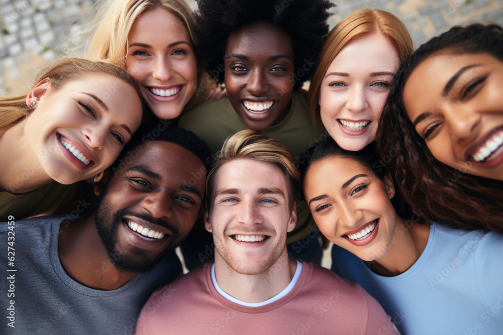 A large multiethnic group of young people take a selfie.