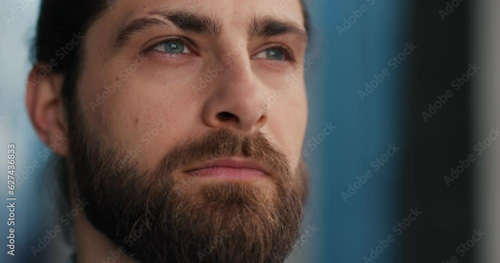 Close up of businessman with beard and long hair, opening his eyes blinking. Close up of businessman with beard and long hair, opening his eyes blinking.
