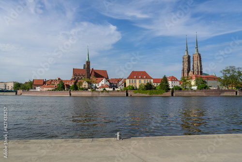 Outdoor view on the waterside of Oder river and background of Archbishop s Palace  Collegiate Church of the Holy Cross and St. Bartholomew and Wie  a Katedry   w. Jana Chrzciciela in Wroclaw  Poland.