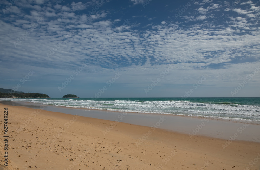 Beautiful beach on a summer day. Blue sky. Sunny day. Yellow sand on the beach.