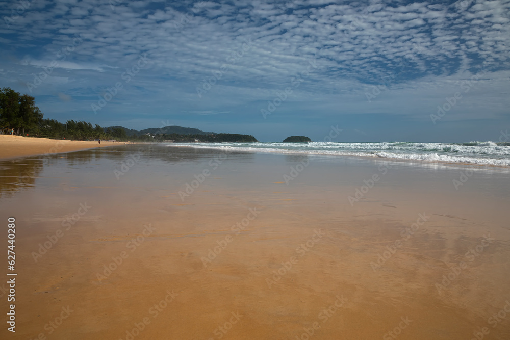 Beautiful beach on a summer day. Blue sky. Sunny day. Yellow sand on the beach.