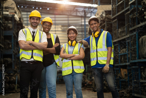 portrait group of engineer employee team staff group diversity worker together in dirty metal factory workshop background