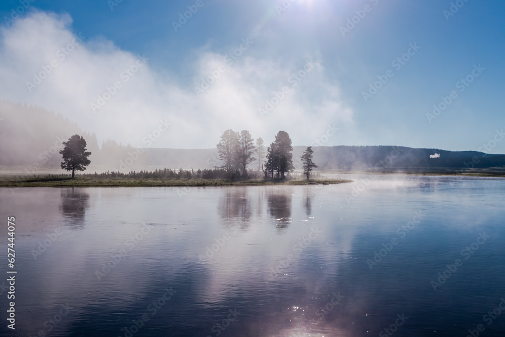 Fototapeta premium Beautiful foggy landscape of the river in morning mist and light. Wyoming, Yellowstone National Park