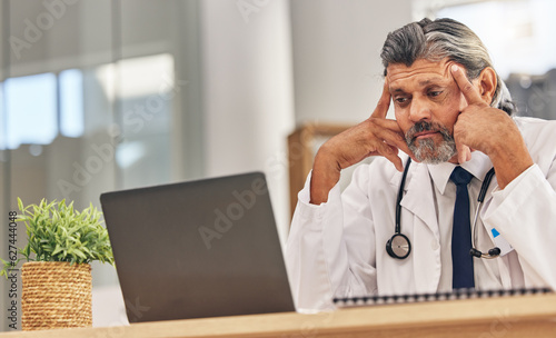Senior doctor man, laptop and headache with stress, 404 glitch or connectivity problem in hospital office. Mature medic, pc and reading bad results for thinking, anxiety and fear in healthcare job
