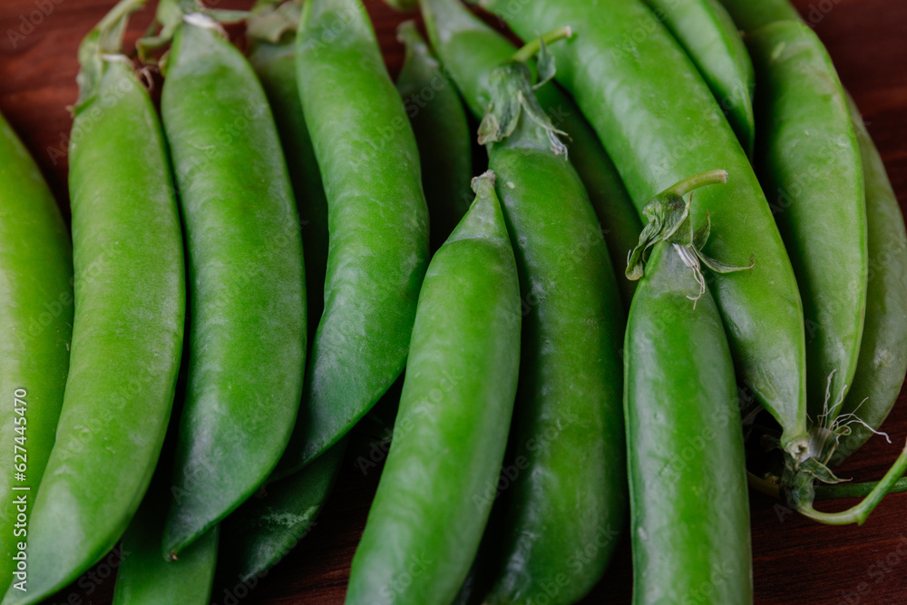 Green pea pods on wooden table. Ripe pea. Green pea pods on wooden table. Ripe pea.