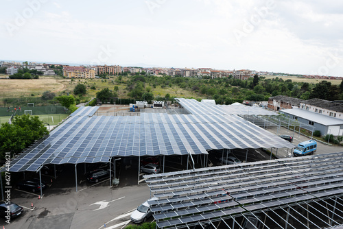 Aerial view of solar panels installed on the roof of car parking.
