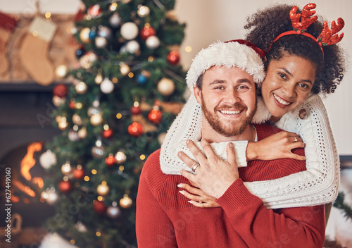 Photo Christmas, portrait and happy couple in home, hug and bonding together