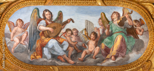 GENOVA, ITALY - MARCH 5, 2023: The fresco of angels choir with the music instrumenst in the church Chiesa del Gesu by Giovanni Carlone from 17. cent.