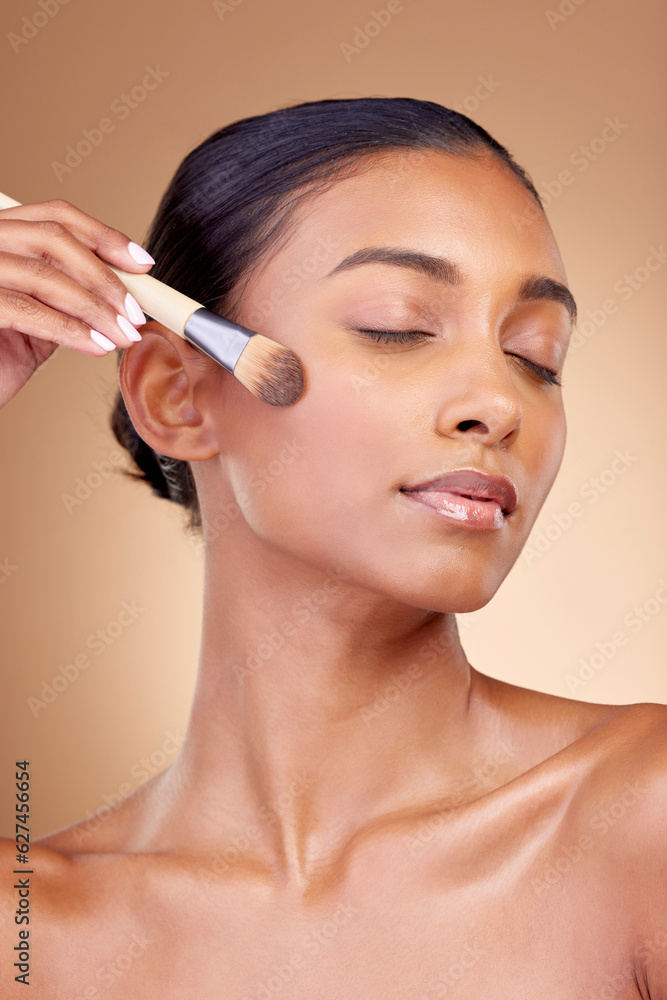 Beauty, makeup and product with woman and brush in studio for facial, foundation and self care. Cosmetics, spa and tools with face of model on brown background for glow, skincare and dermatology