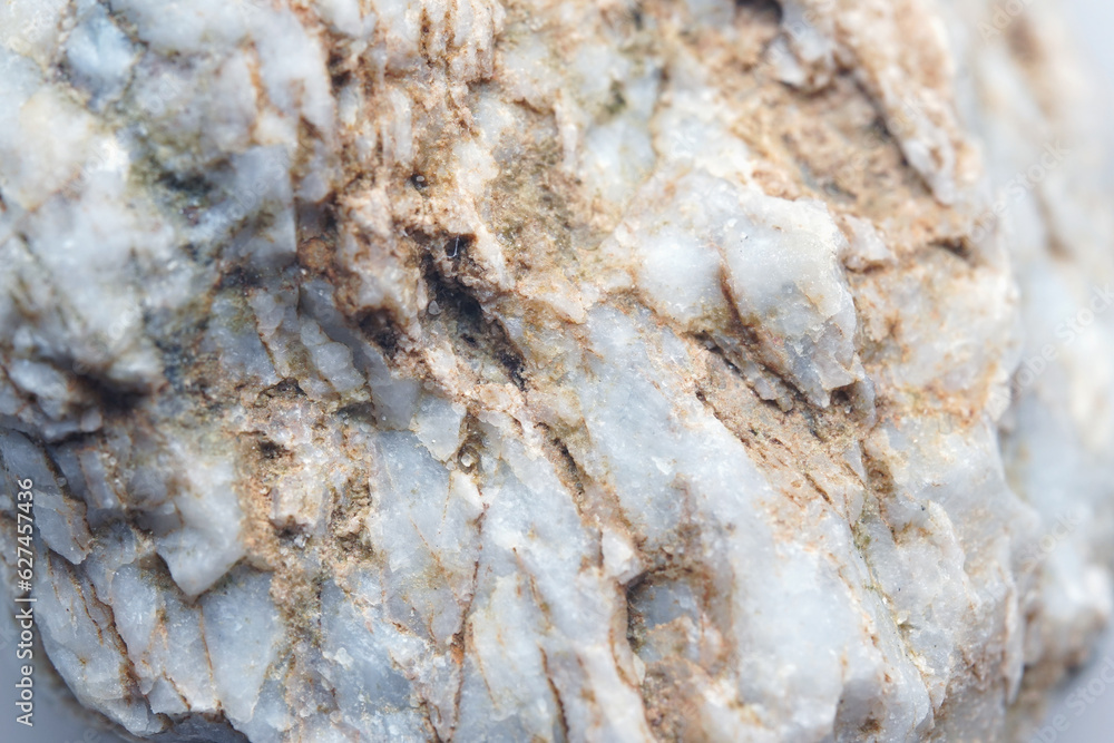 A piece of raw marble. Macro shooting of metamorphic rock specimens - marble stone A piece of raw marble. Macro shooting of metamorphic rock specimens - marble stone