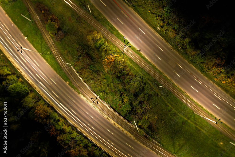 Top down view to road. Romantic night aerial photo of cars traveling. The light on the road at night in city. Background scenic road drone view. Tram railways background Top down view to road. Romantic night aerial photo of cars traveling. The light on the road at night in city. Background scenic road drone view. Tram railways background
