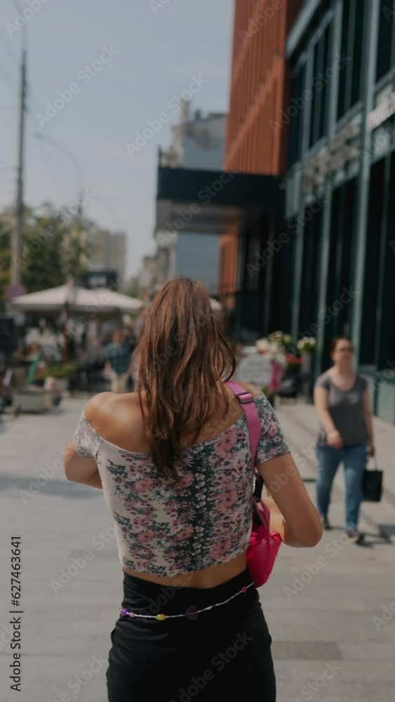 The fashionable, young woman is rushing through the city streets, running behind schedule for work. The fashionable, young woman is rushing through the city streets, running behind schedule for work.