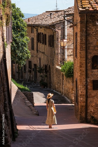 Beautiful female model on the old city streets of San Gimignano, Tuscany, Italy © Adi Seres