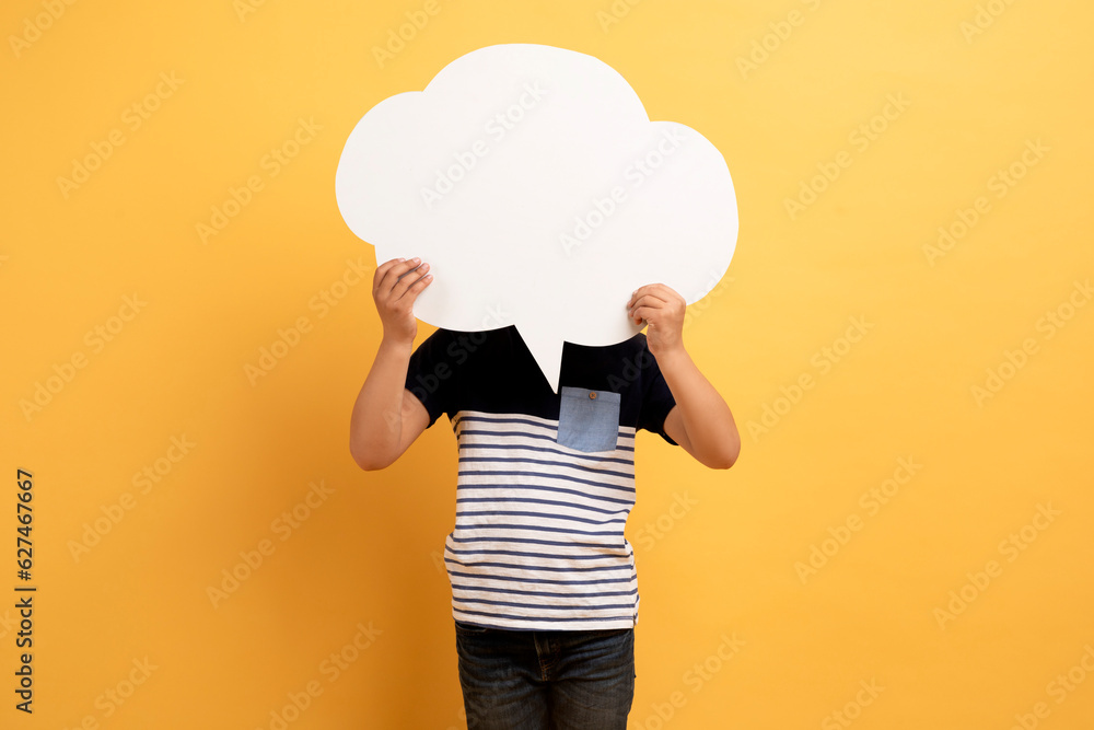 Preteen child holding empty white communication bubble over his head Preteen child holding empty white communication bubble over his head