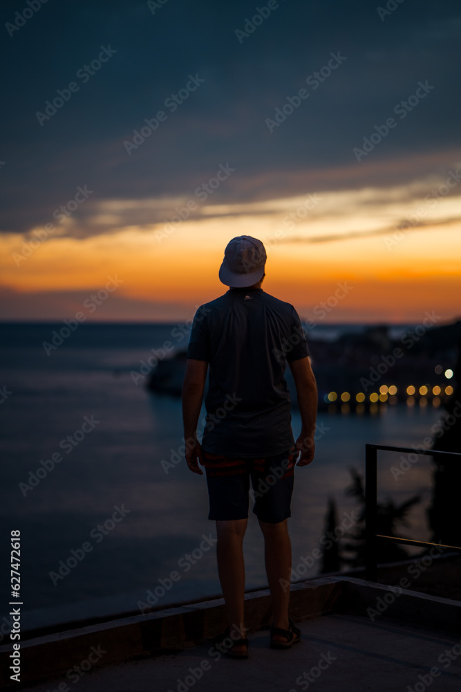 Fototapeta premium Beautiful male model on the streets of Dubrovnik. Amzing golden sunset.