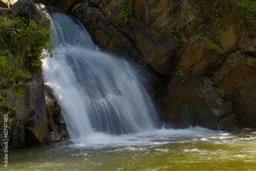 Zaskalnik waterfall at the foot of the mountains  hidden in the forest