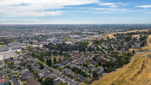 Aerial images over a neighborhood in Hayward, California with a blue sky and room for text. photo